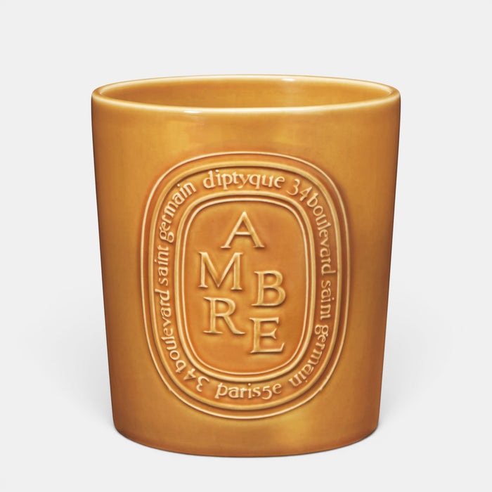 Shop Rescue Spa Ambre scented candle in a glossy amber-colored ceramic vessel with embossed branding.