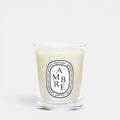 Shop Rescue Spa Ambre scented candle in a clear glass jar with a signature oval white label and woody fragrance.