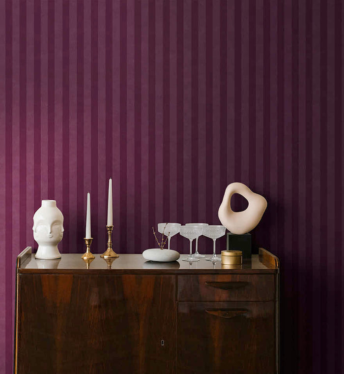 Aquila Stripes wallpaper in berry on a feature wall
