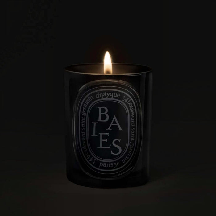 Shop Rescue Spa Baies scented candle in a black glass vessel with a glowing flame against a dark background
