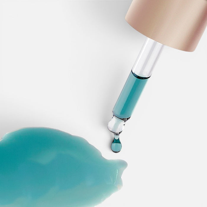 Shop Rescue Spa Black Baccara Longevity Noir Oil with a glass dropper dispensing a blue serum drop onto a surface.