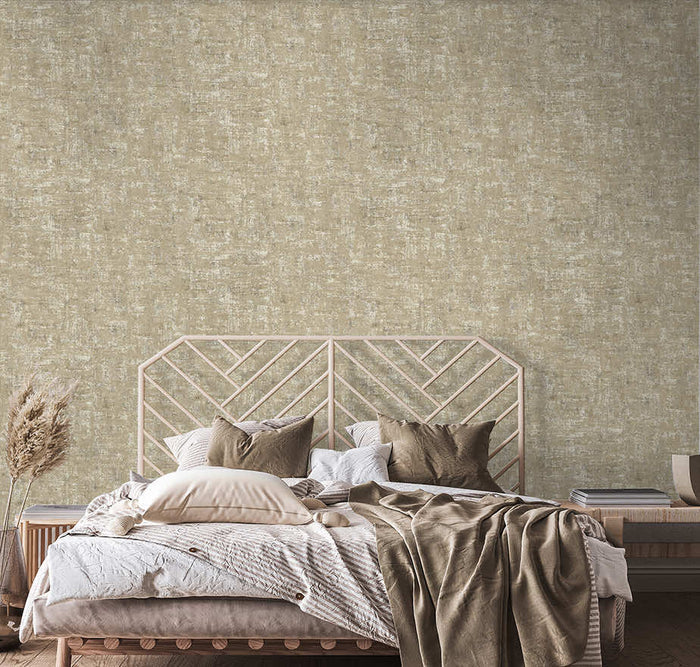Brindle Bead wallpaper in taupe/gold on a bedroom feature wall with a warm metallic glow