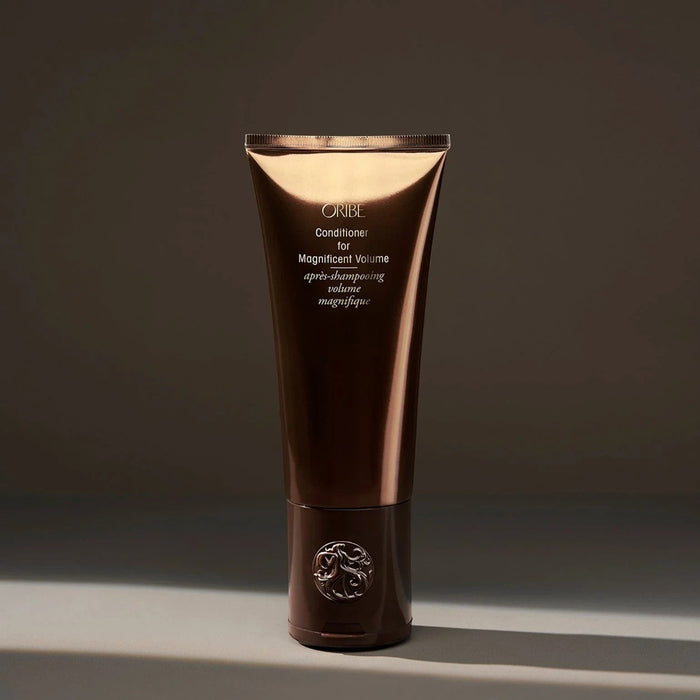 Shop Rescue Spa Oribe Conditioner for Magnificent Volume, a volumizing conditioner for fine to medium hair in a brown tube.