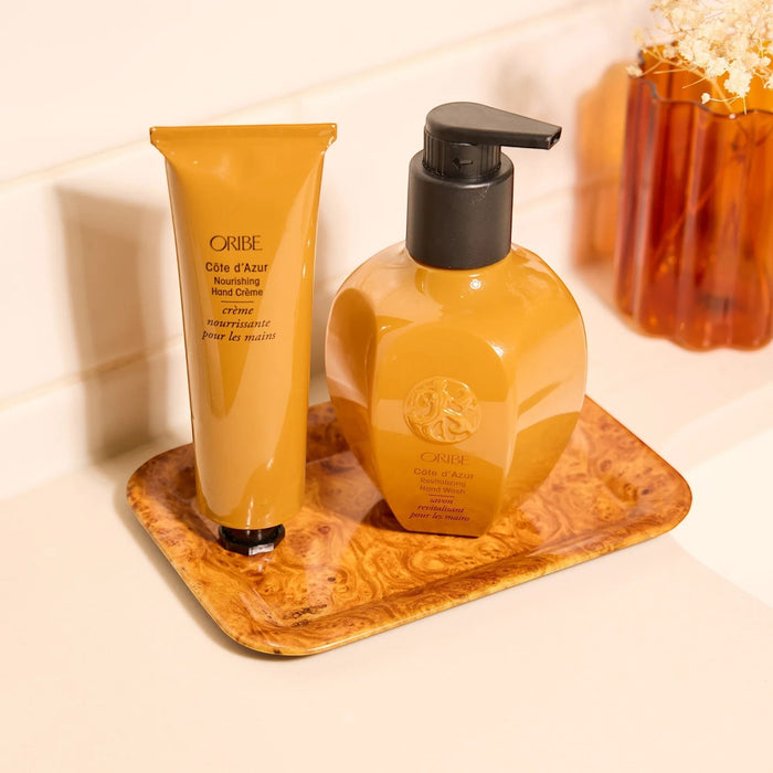 Shop Rescue Spa ORIBE Cote d'Azur Nourishing Hand Creme in amber tube and matching pump bottle.