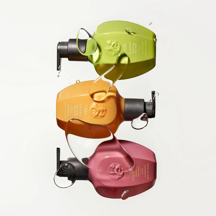 Shop Rescue Spa Oribe Cote d'Azur Revitalizing Hand Wash in green, orange, and pink bottles with clear liquid drips.