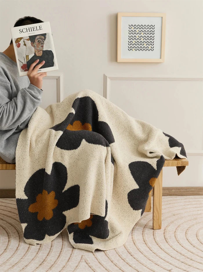 Floral microfiber knit throw blanket with a plush, modern design, anti-pilling, and wearable comfort