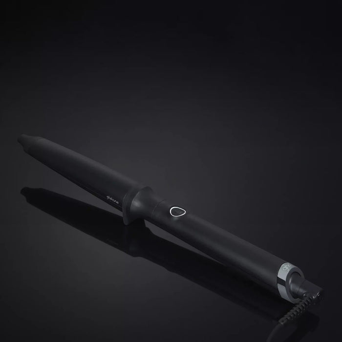 Shop Rescue Spa ghd curve creative curl tapered wand in matte black for beachy waves on a dark reflective surface