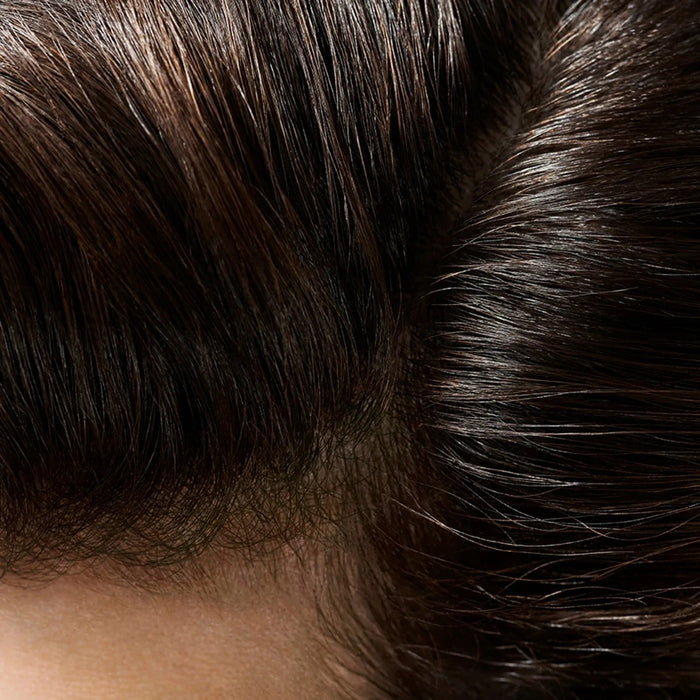 Shop Rescue Spa Creme for Style applied to dark hair, showing a healthy, shiny, and frizz-free finish.