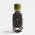 Shop Rescue Spa Oribe Desertland eau de parfum in a clear glass bottle with a matte olive green cap.