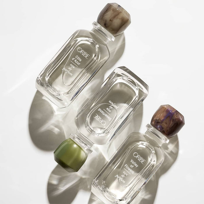 Shop Rescue Spa Desertland Eau De Parfum, clear glass bottle with marbled brown cap and green accents.