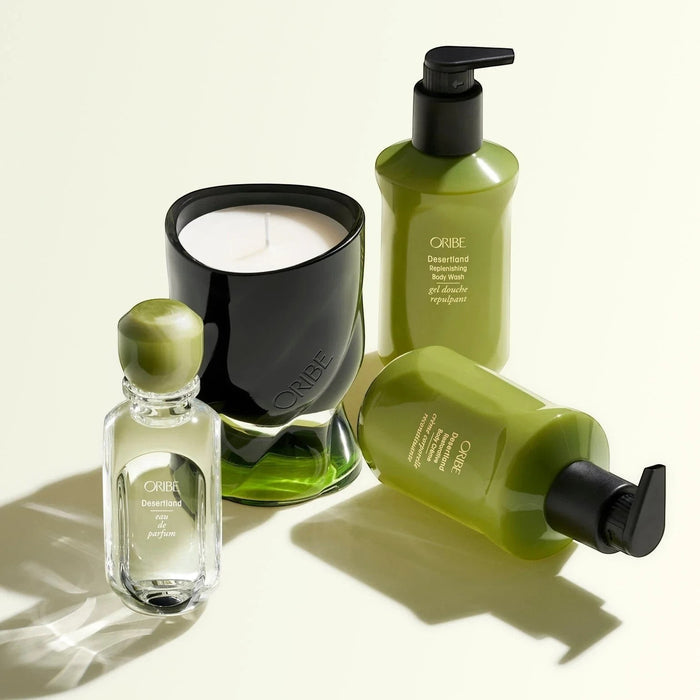 Oribe Desertland Replenishing Body Wash 300ml in a green pump bottle, alongside eau de parfum and candle.
