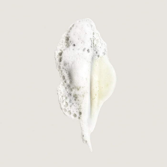Shop Rescue Spa Eternal Curls Moisturizing Shampoo foam swatch with white bubbles and a hint of yellow
