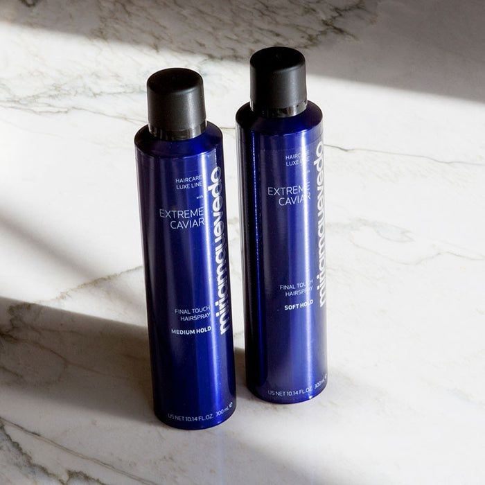 Shop Rescue Spa Extreme Caviar medium hold hairspray in blue 300mL aerosol canisters on a marble surface.