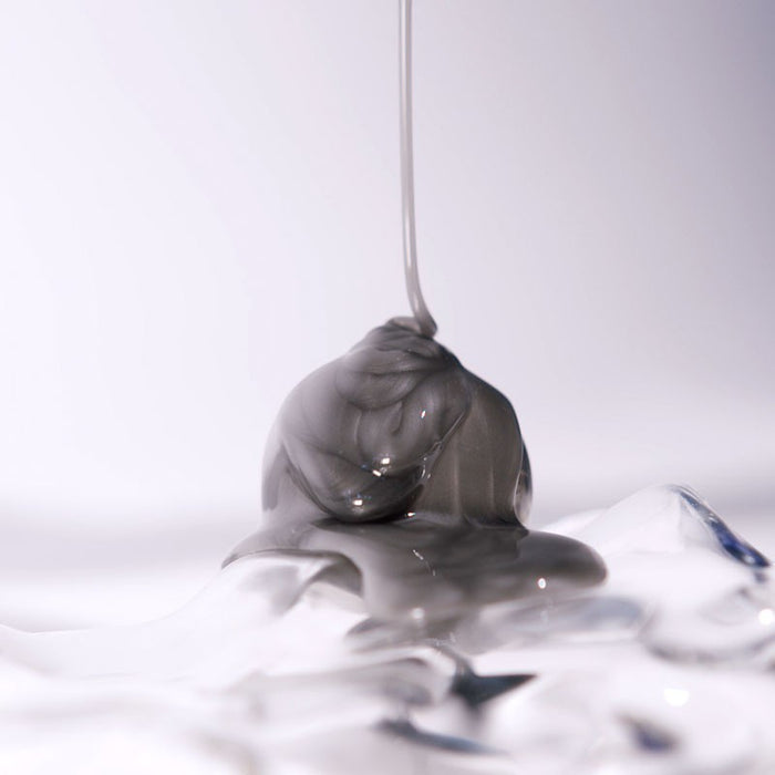 Shop Rescue Spa Extreme Caviar Purifying Charcoal Shampoo with a thick grey charcoal texture dripping