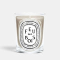 Shop Rescue Spa Diptyque Feu de Bois scented candle in a clear glass vessel with a beige wax finish