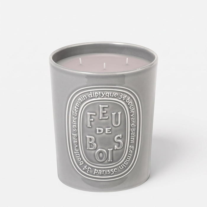 Shop Rescue Spa Feu De Bois scented candle in a grey ceramic vessel with embossed branding