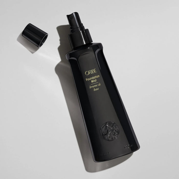 Shop Rescue Spa ORIBE Foundation Mist hair primer spray for shine, detangling, and heat protection. Black bottle with gold lettering.