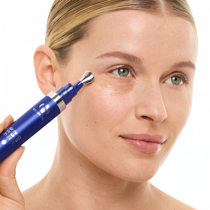 Shop Rescue Spa GeneXC Firming Eye Gel being applied with a cooling metal applicator tip to a woman's under-eye area.