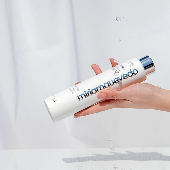 Shop Rescue Spa Glacial White Caviar Hydra-Pure Rescue Masque in a white bottle held by a hand with water droplets