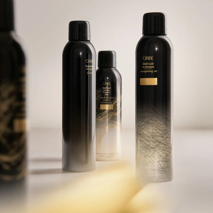 Shop Rescue Spa Oribe Gold Lust Dry Shampoo and hair styling spray bottles in black and gold packaging.