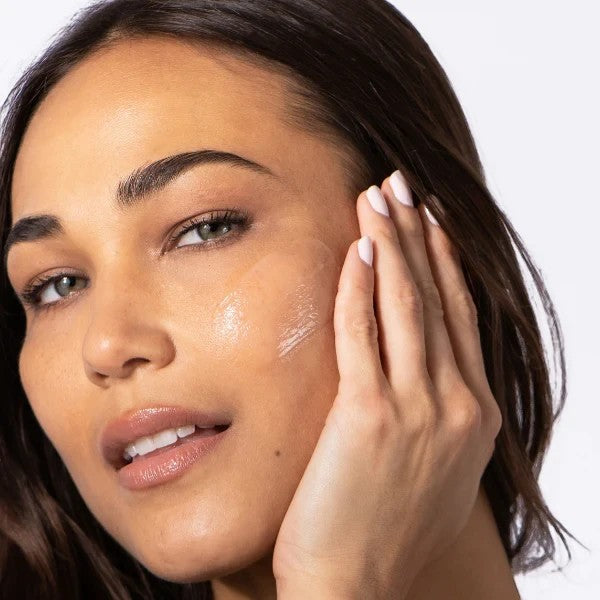 Shop Rescue Spa HA IMMERSE serum applied to a woman's cheek for radiant, hydrated skin
