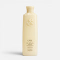 Shop Rescue Spa Oribe Hair Alchemy Fortifying Treatment Serum in a pale yellow bottle with embossed logo detail.