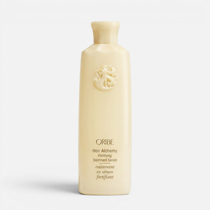 Shop Rescue Spa Oribe Hair Alchemy Fortifying Treatment Serum in a pale yellow bottle with embossed logo detail.