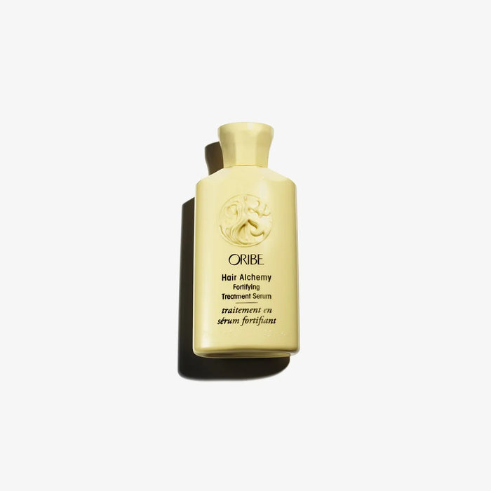 Shop Rescue Spa Oribe Hair Alchemy Fortifying Treatment Serum in a pale yellow bottle for strengthening hair.