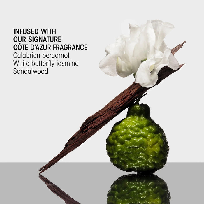 Shop Rescue Spa Hair Alchemy serum ingredients featuring a bergamot fruit, a white flower, and a piece of wood.