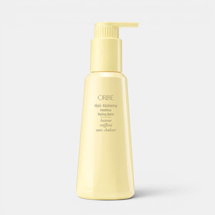 Shop Rescue Spa Oribe Hair Alchemy Heatless Styling Balm in a pale yellow pump bottle for defining air-dried waves.