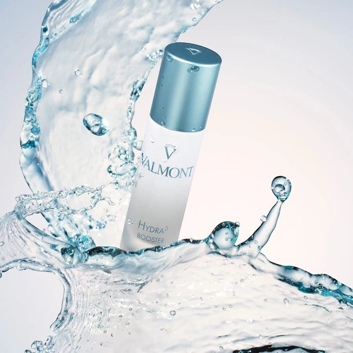 Shop Rescue Spa Valmont Hydra3 Booster serum bottle surrounded by a dynamic splash of water for hydration concept
