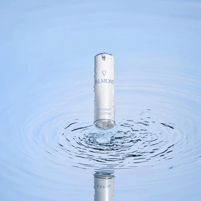 Shop Rescue Spa Valmont Hydra3 Contour eye cream bottle hovering above water ripples, symbolizing deep hydration.