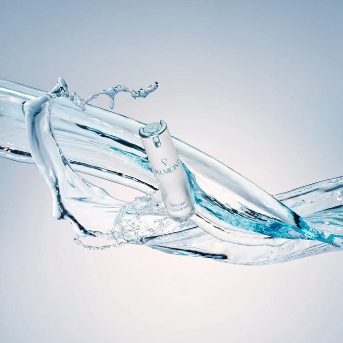 Shop Rescue Spa Valmont Hydra3 Contour eye cream bottle surrounded by a dynamic splash of clear water