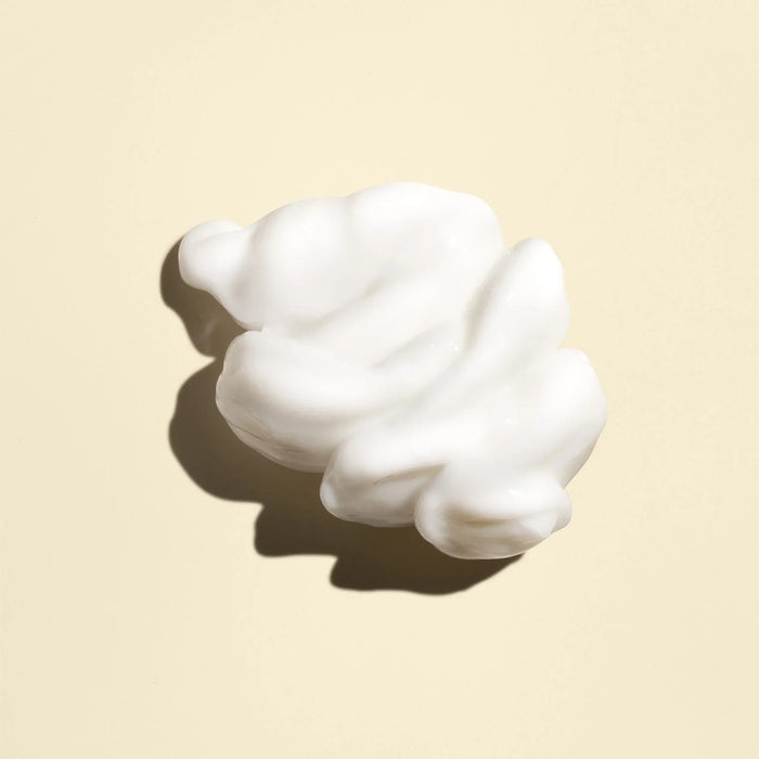 Shop Rescue Spa Imperial Blowout Transformative Styling Creme white hair styling cream texture on a beige background