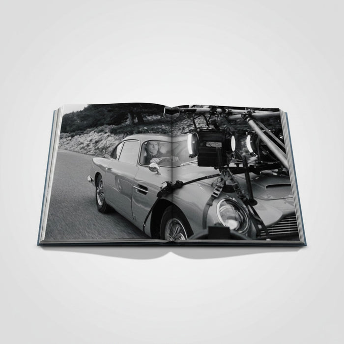 Shop Rescue Spa James Bond Cars book features an Aston Martin DB5 on a scenic road, with film equipment attached.