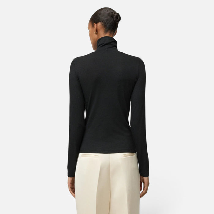 Shop Rescue Spa black lightweight jersey turtleneck worn by a model, back view showing long sleeves and slim fit.