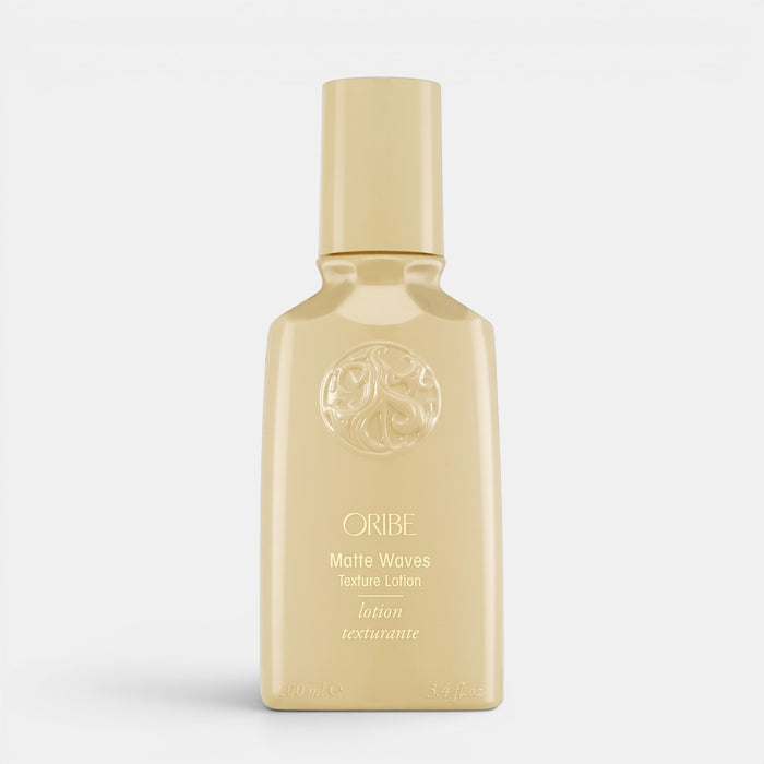 Shop Rescue Spa Oribe Matte Waves Texture Lotion in a beige bottle for beachy hair waves and matte finish
