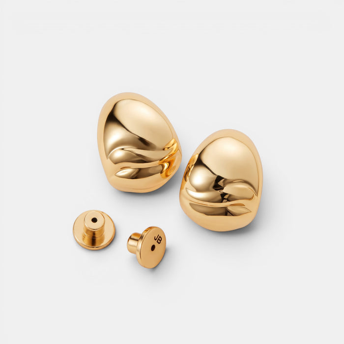 Shop Rescue Spa Nelle gold hoop earrings with organic rippled texture and high-polish finish, including flat disc backs.