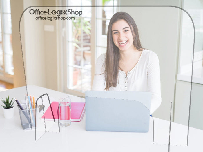 Woman at desk with laptop behind plexiglass shield divider, Office Logix Shop branding visible.