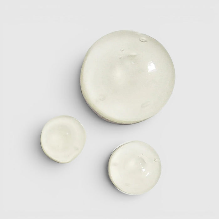Shop Rescue Spa Regenerating Skin Nectar serum texture shown as three clear, viscous drops on a white background.
