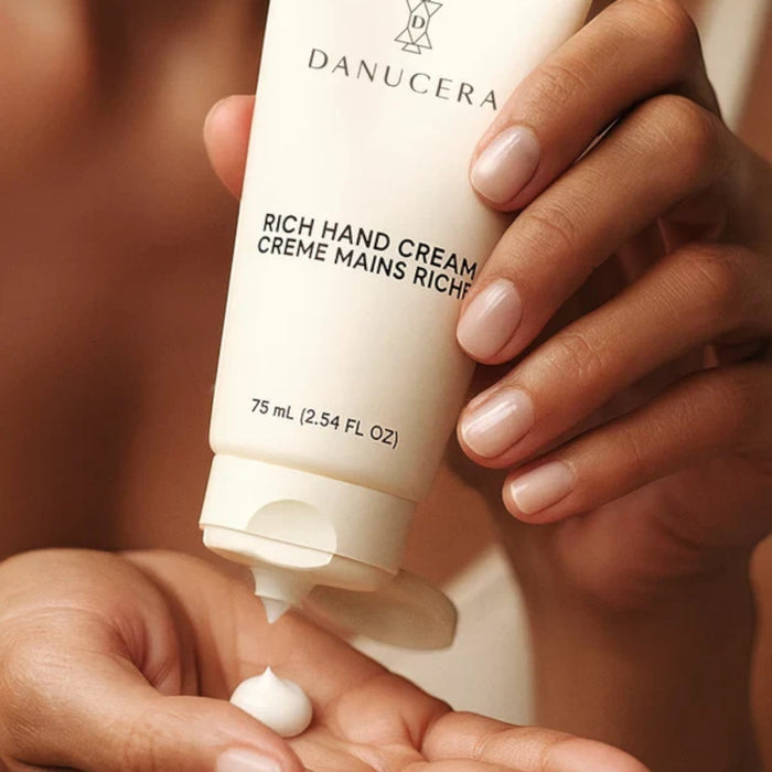 Shop Rescue Spa Danucera Rich Hand Cream being dispensed onto a palm for intensive repair and hydration.