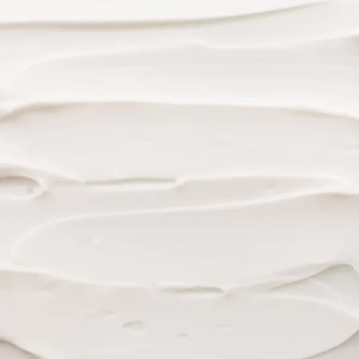 Shop Rescue Spa Rich Hand Cream texture showing a smooth, thick white moisturizing cream spread in soft swirls.