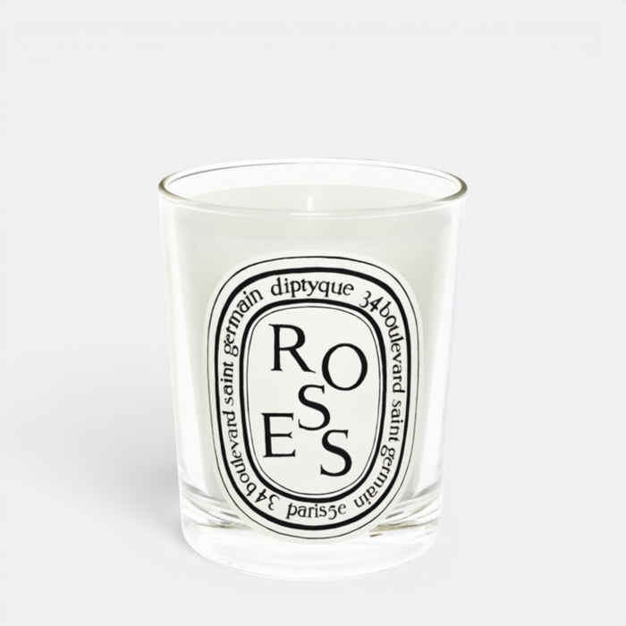 Shop Rescue Spa Roses scented candle in a clear glass jar with a white wax finish and signature oval label