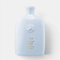 Shop Rescue Spa Oribe Run-Through Detangling Shampoo in a light blue bottle for smooth, knot-free hair.