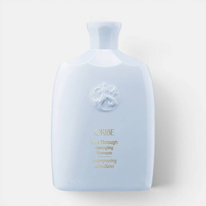 Shop Rescue Spa Oribe Run-Through Detangling Shampoo in a light blue bottle for smooth, knot-free hair.