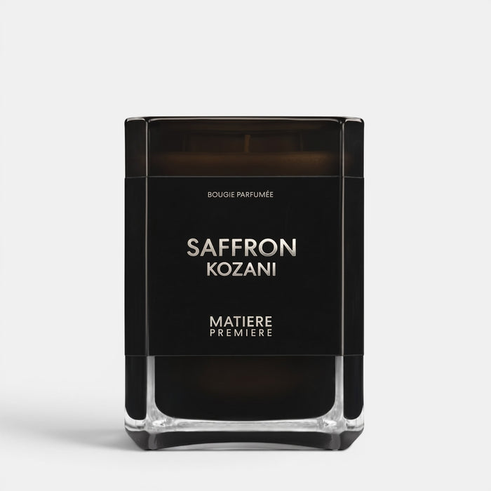 Shop Rescue Spa Saffron Kozani scented candle in a sleek black glass jar with minimalist white typography.