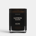 Shop Rescue Spa Saffron Kozani scented candle in a sleek black glass jar with minimalist white typography.