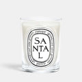 Shop Rescue Spa Diptyque Santal scented candle in a clear glass vessel with a white wax finish