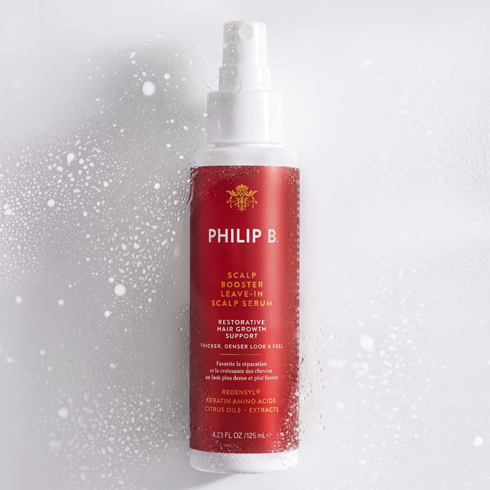 Shop Rescue Spa Philip B. Scalp Booster leave-in serum bottle with water droplets on a white background.