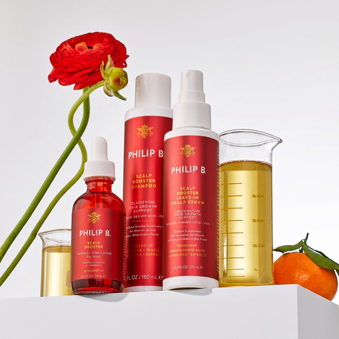Shop Rescue Spa Philip B Scalp Booster hair care collection with pre-wash, shampoo, and serum bottles on a white stand.